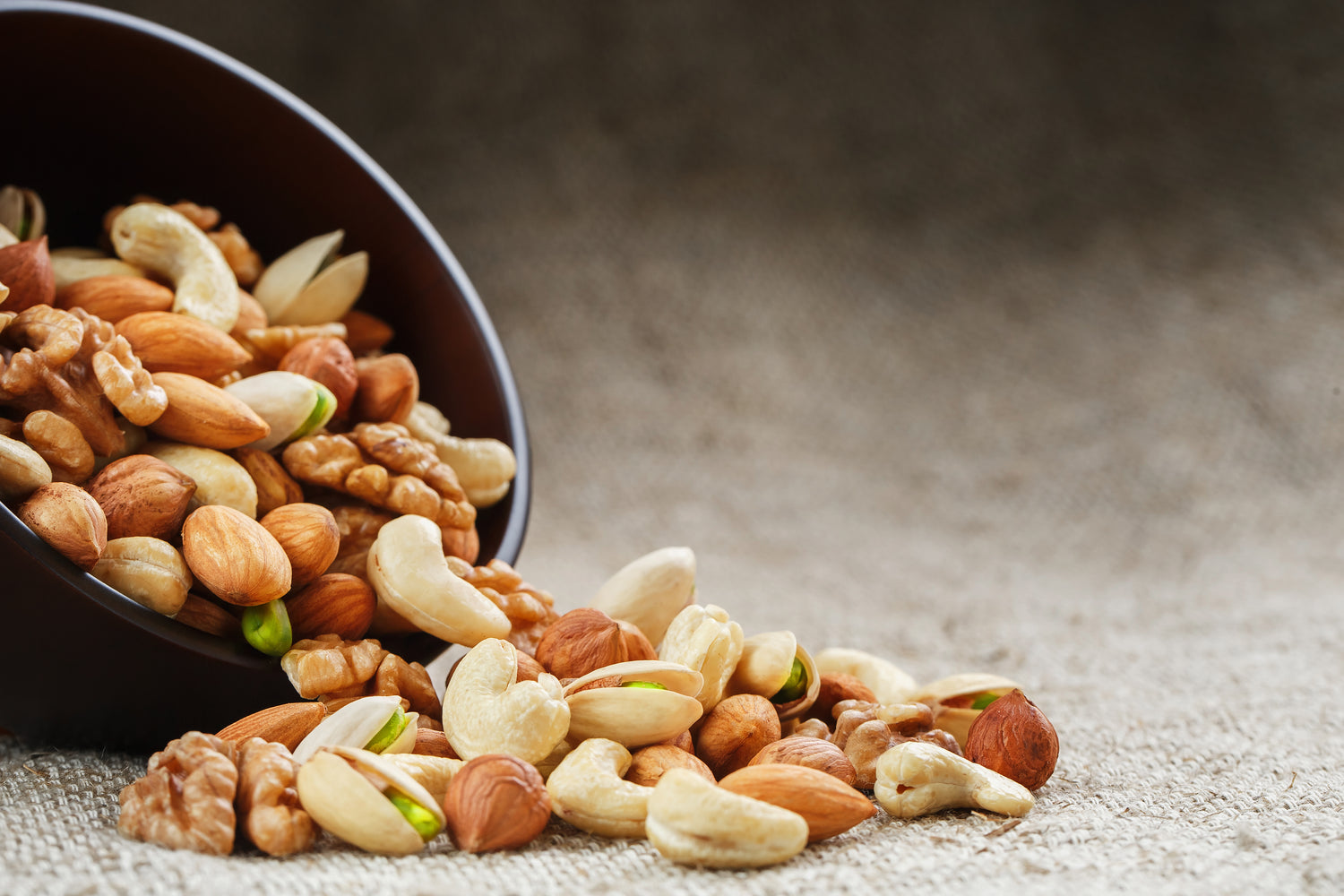 Healthy Mix Dry Fruits and Nuts on dark background. Almonds, Pistachio,  Cashews, Raisins Stock Photo - Alamy